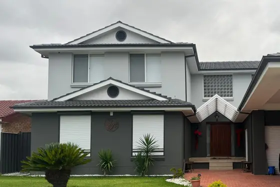 Front of a renovated two-storey home with a two-tone grey finish in Chipping Norton, by St Anthony Building Group
