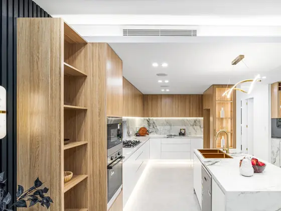 Kitchen with marble island in a knockdown rebuild in Chipping Norton by St Anthony Building Group