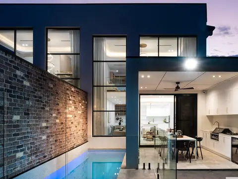 Rear of a knockdown rebuild in Sutherland at dusk with pool, a St Anthony Building Group project