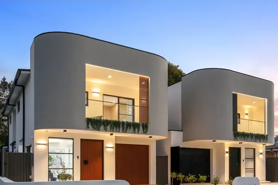 Two new double-storey homes at dusk, a knockdown rebuild at 28 Aylesbury Crescent, Chipping Norton by St Anthony Building Group