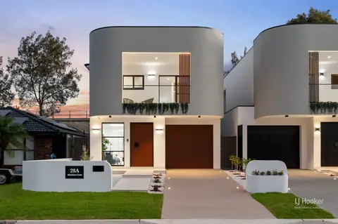 Front of two new double-storey homes at dusk – knockdown rebuild at 28 Aylesbury Crescent, Chipping Norton