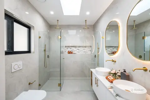 Bathroom with walk-in shower, two basins and backlit mirrors – knockdown rebuild at 28 Aylesbury Crescent, Chipping Norton