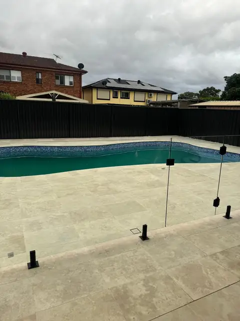 Pool with pale paving and frameless glass pool fencing – renovation at 21 Aylesbury Crescent, Chipping Norton