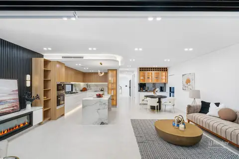 Open-plan living area with linear fireplace and kitchen beyond – knockdown rebuild at 28 Aylesbury Crescent, Chipping Norton