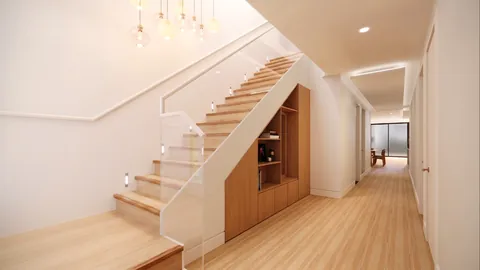Architectural render: Staircase with timber treads, a glass balustrade, step lights and built-in joinery under the stairs – duplex in Sylvania