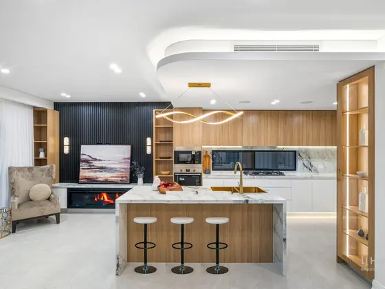 Kitchen with island bench and stone-look benchtops in a knockdown rebuild in Chipping Norton by St Anthony Building Group